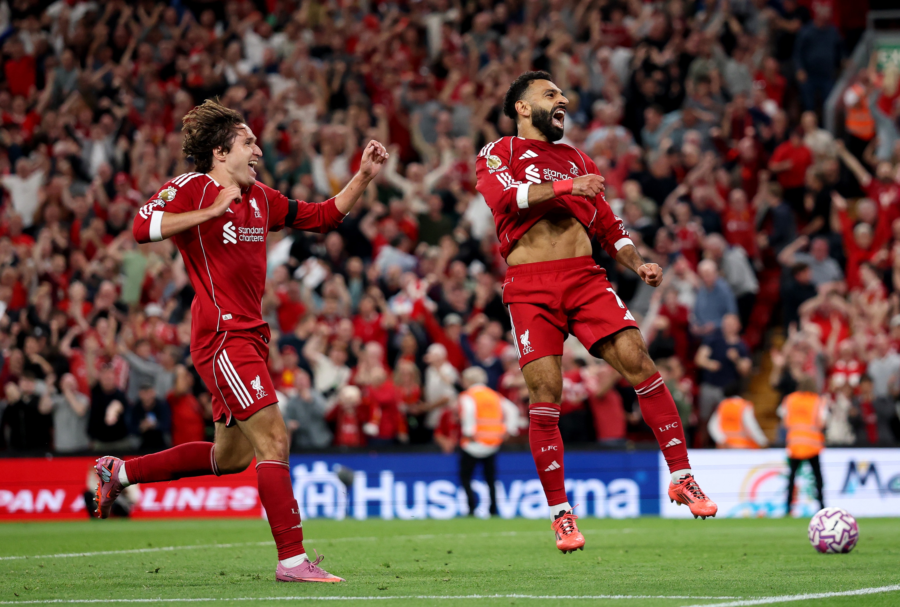 Federico Chiesa celebrating with Mohamed Salah at Anfield