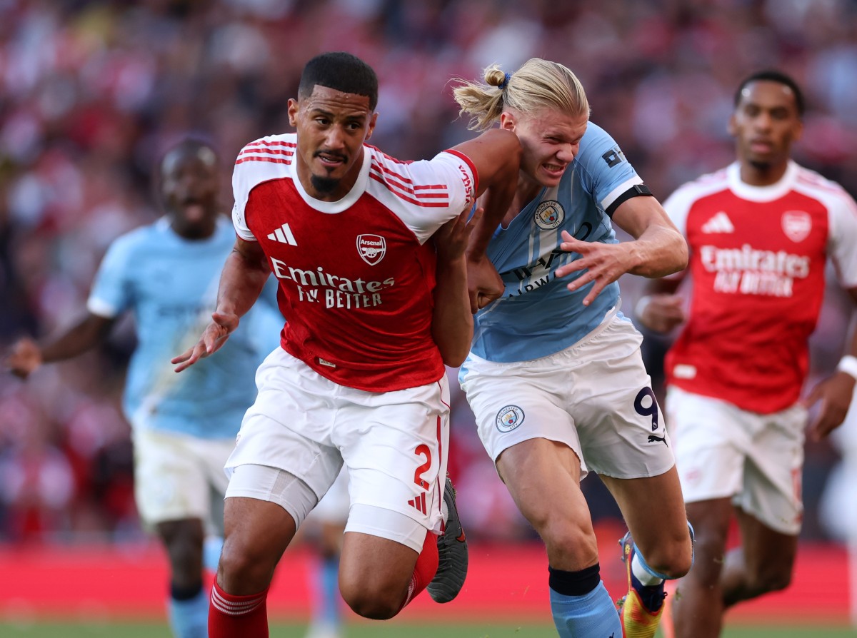 William Saliba of Arsenal in action against Manchester City's Erling Haaland