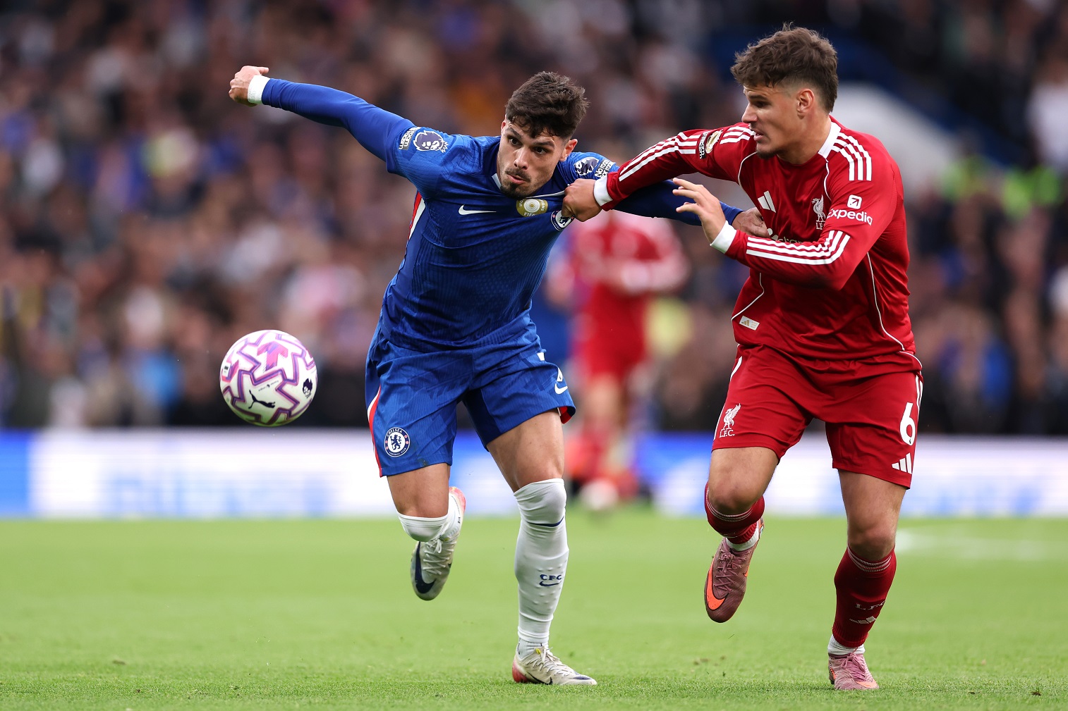 Pedro Neto of Chelsea battles for possession with Milos Kerkez of Liverpool