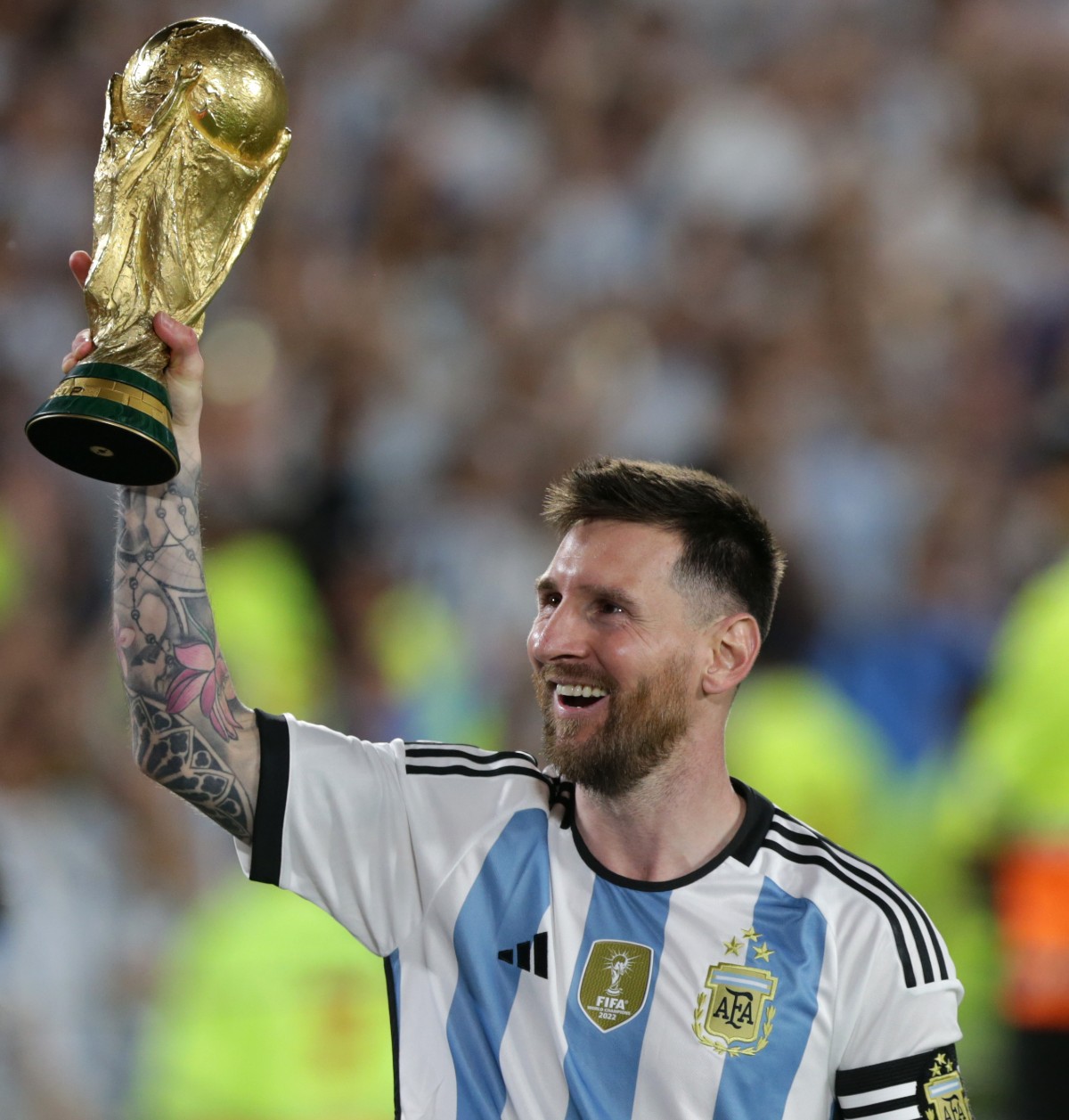 Lionel Messi holding the World Cup trophy