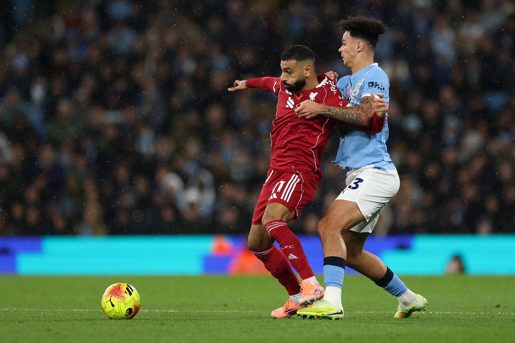Mohamed Salah of Liverpool is challenged by Nico O'Reilly of Man City