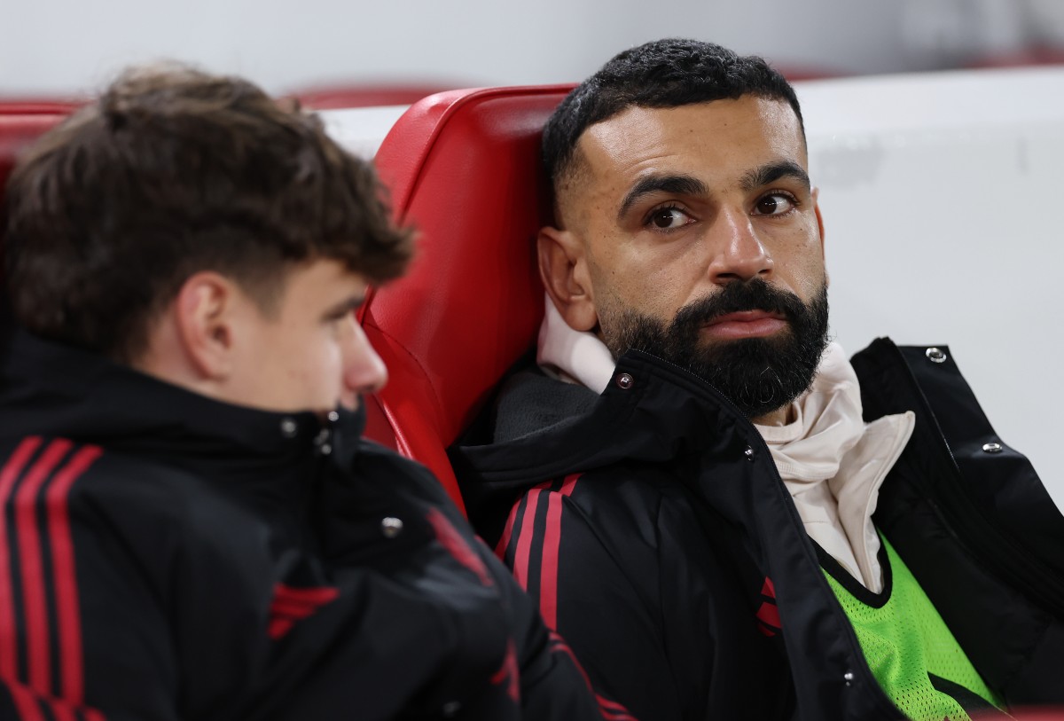 Mohamed Salah looks on from the Liverpool bench