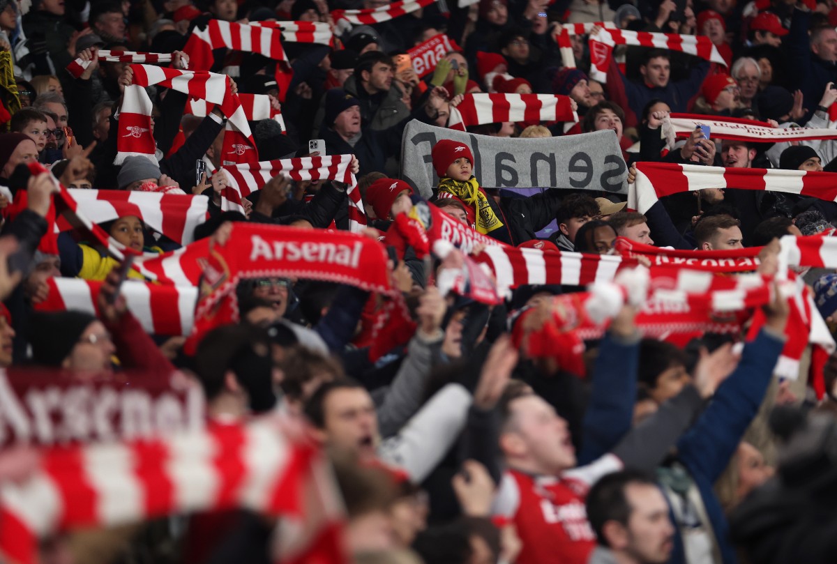 Arsenal fans holding up their scarves