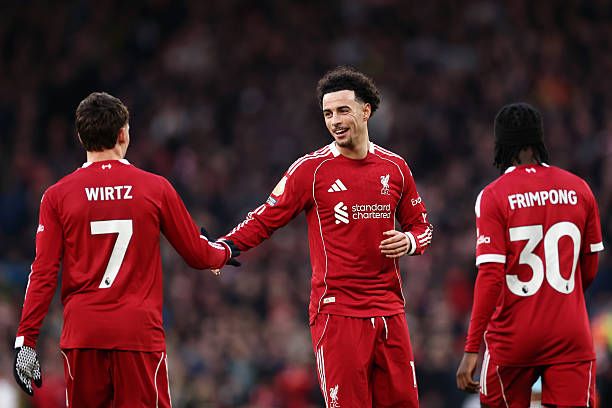 Curtis Jones of Liverpool congratulates team-mate Florian Wirtz after he scored their team's first goal during the Premier League match between Liverpool and Burnley at Anfield