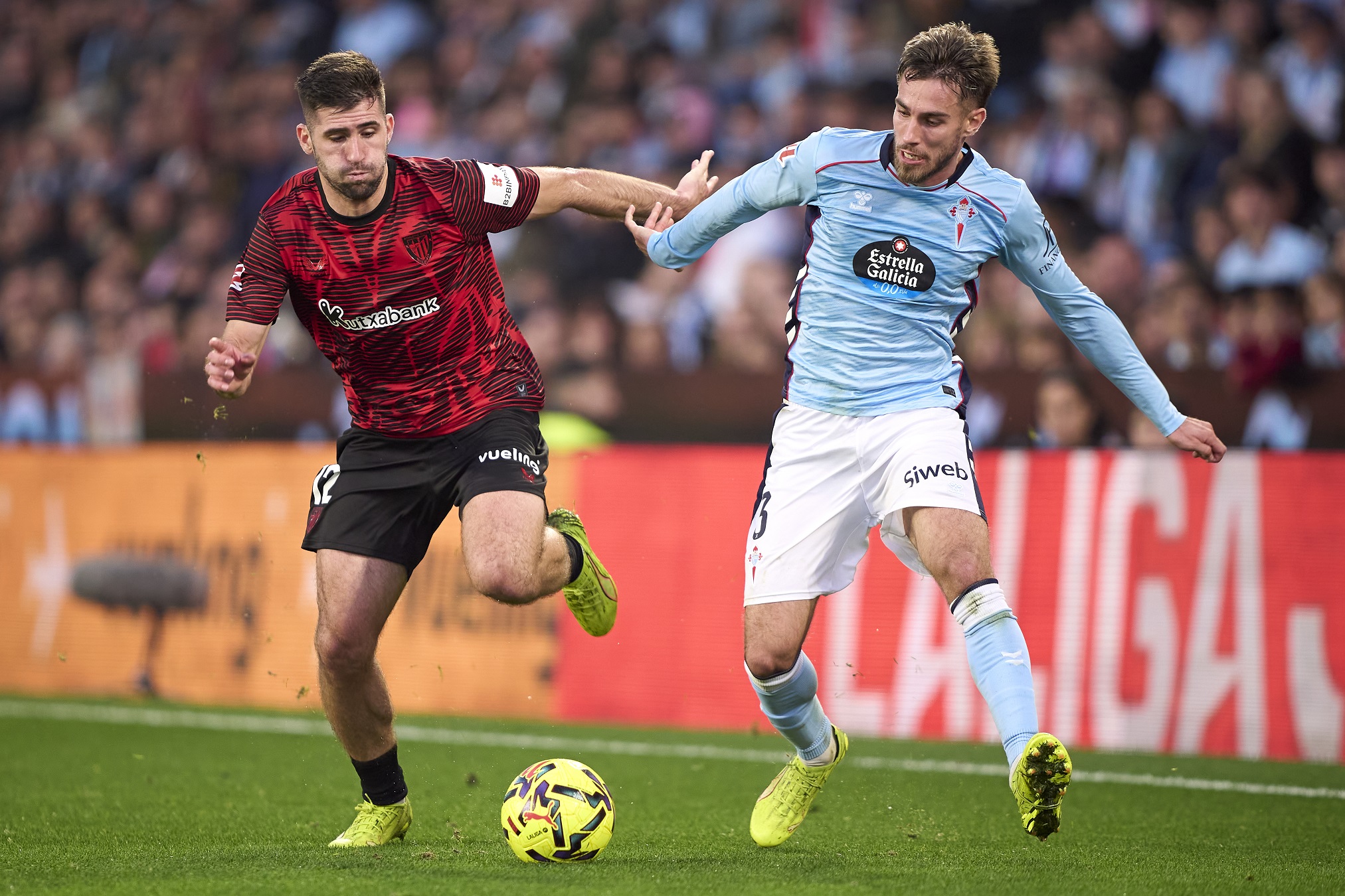 Jesus Areso of Athletic Club competes for the ball with Oscar Mingueza of Celta de Vigo