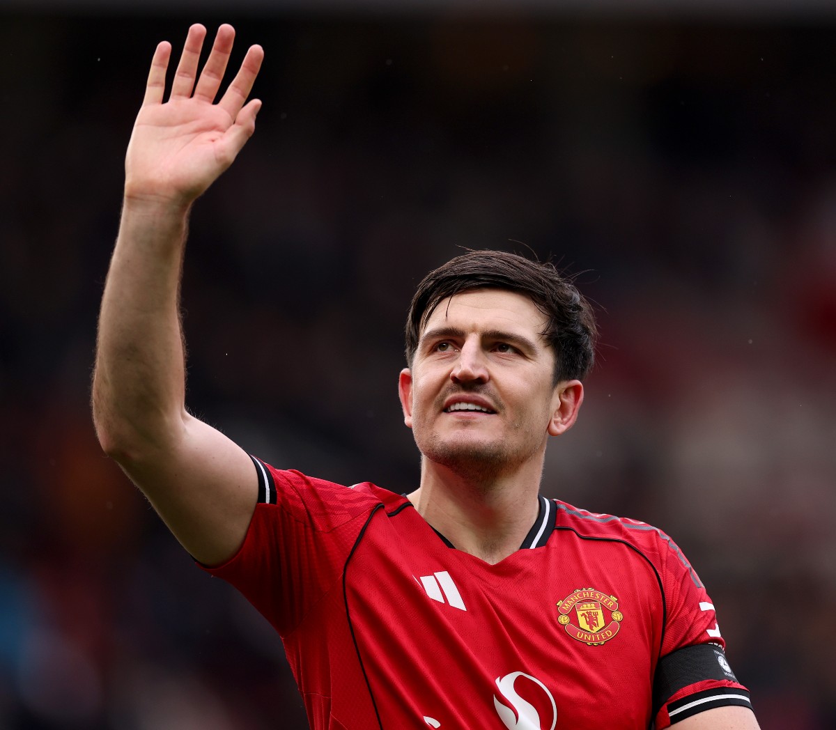Harry Maguire waves to the Manchester United fans