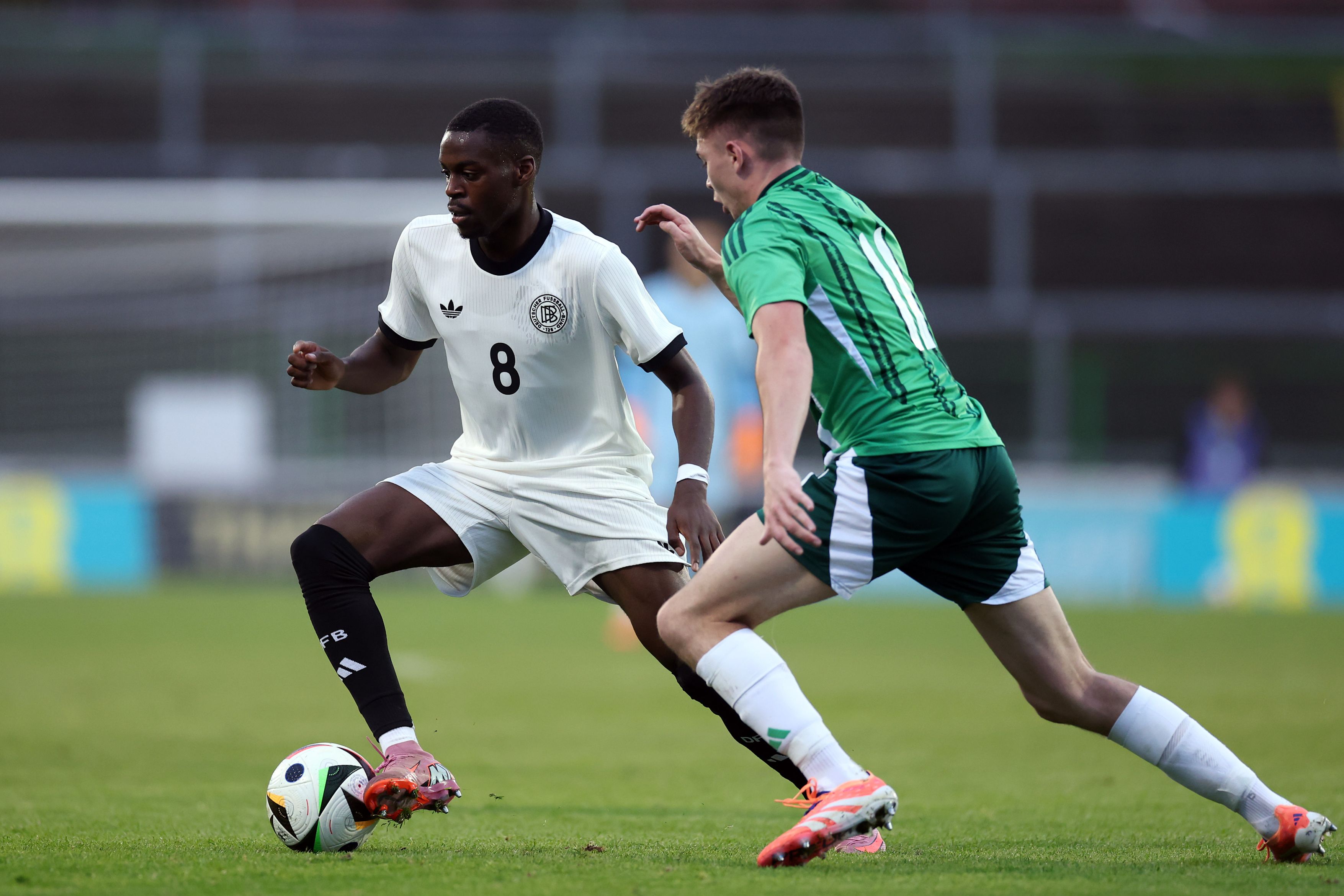  Noel Aseko of Germany U21 controls the ball under pressure from Patrick Kelly of Northern Ireland U21