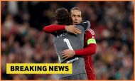 Alisson Becker hugs Virgil van Dijk