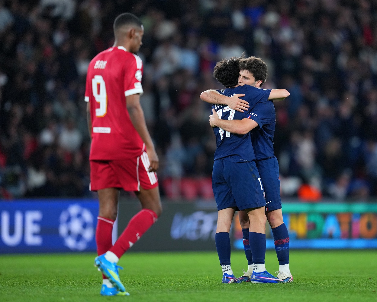Joao Neves of Paris Saint-Germain hugs his teammate Vitinha