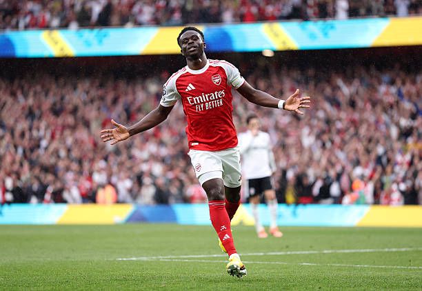 Saka celebrates after scoring