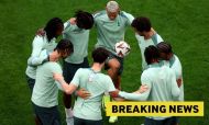 Richarlison of Tottenham Hotspur controls the ball with teammates in a huddle.
